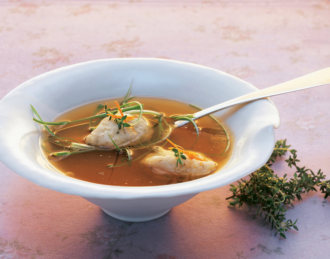 Lamb broth with semolina dumplings in bowl