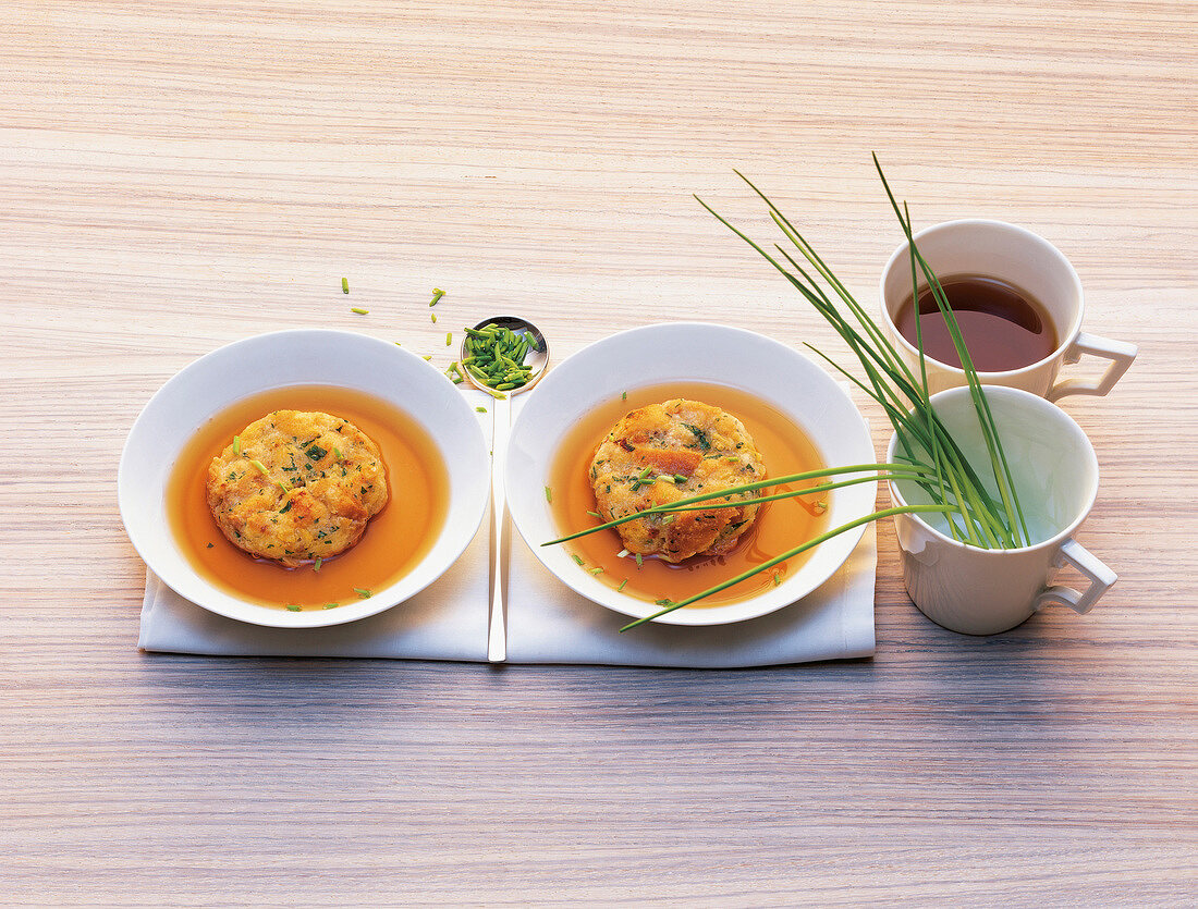 Pasta and cheese dumplings in beef consomme in serving dishes