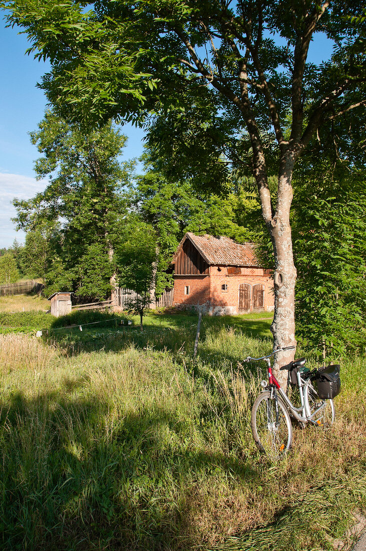 View of bicycle with house overlooking at Warmia-Masuria Masuria near Mikolajki, Poland