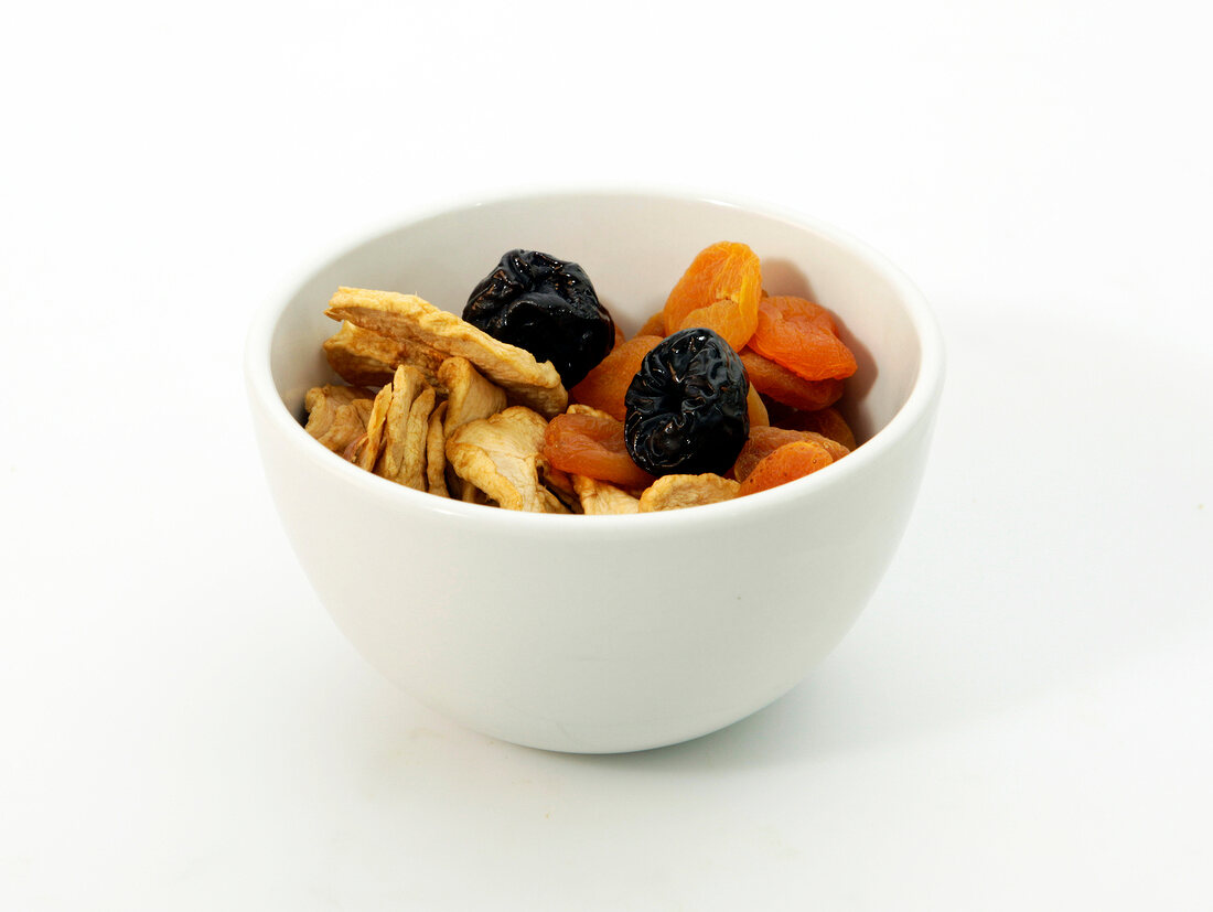 Mixed dry fruits in bowl on white background