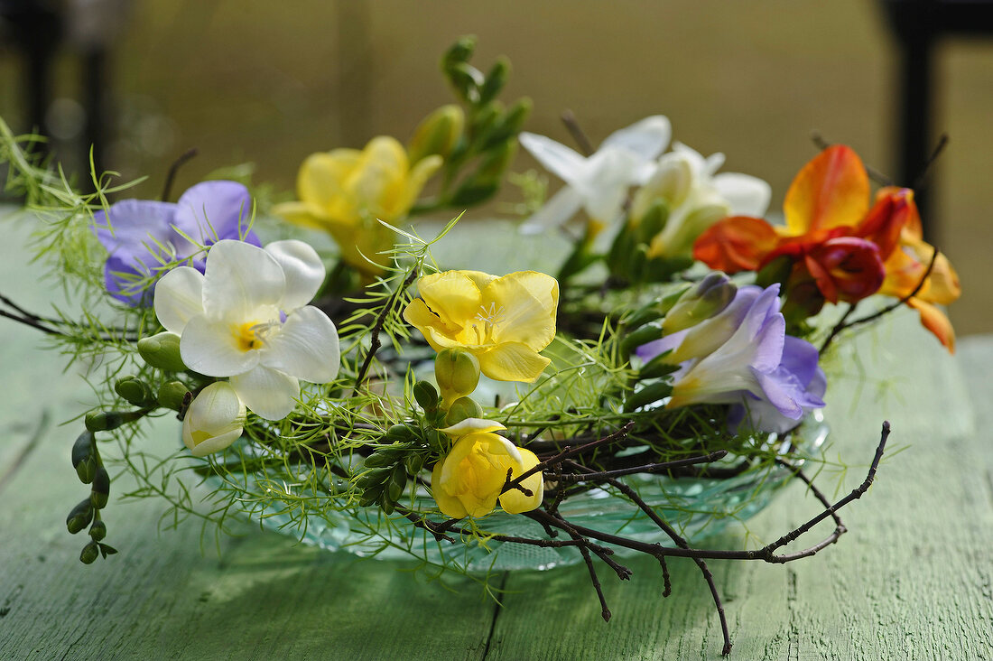 Bouquet aus bunten Freesien in einer Glasschale