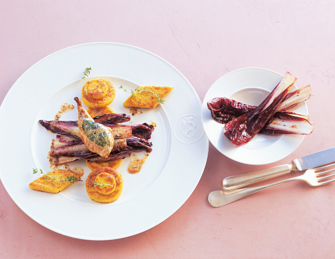 Polenta with radicchio and quail chops on plates
