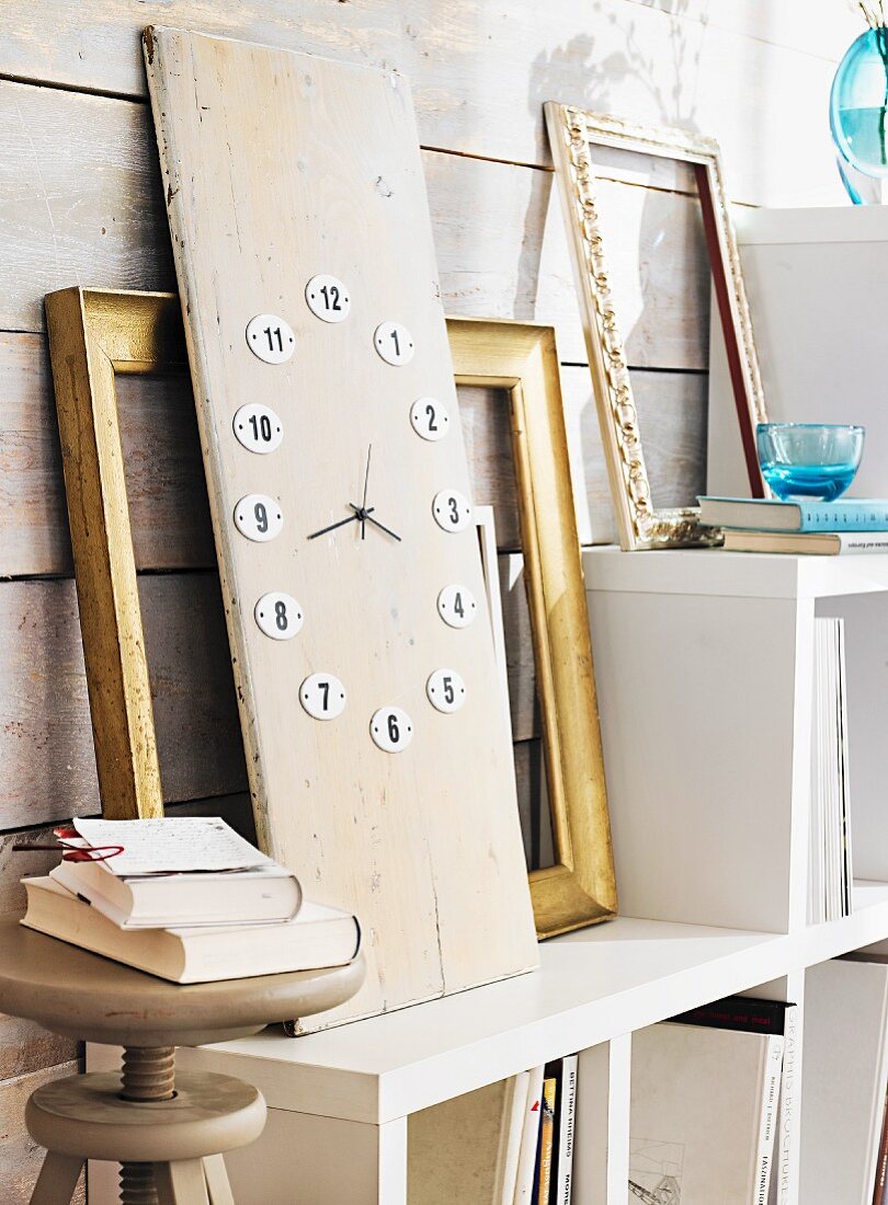 Tall clock made from wooden board and enamel numbers