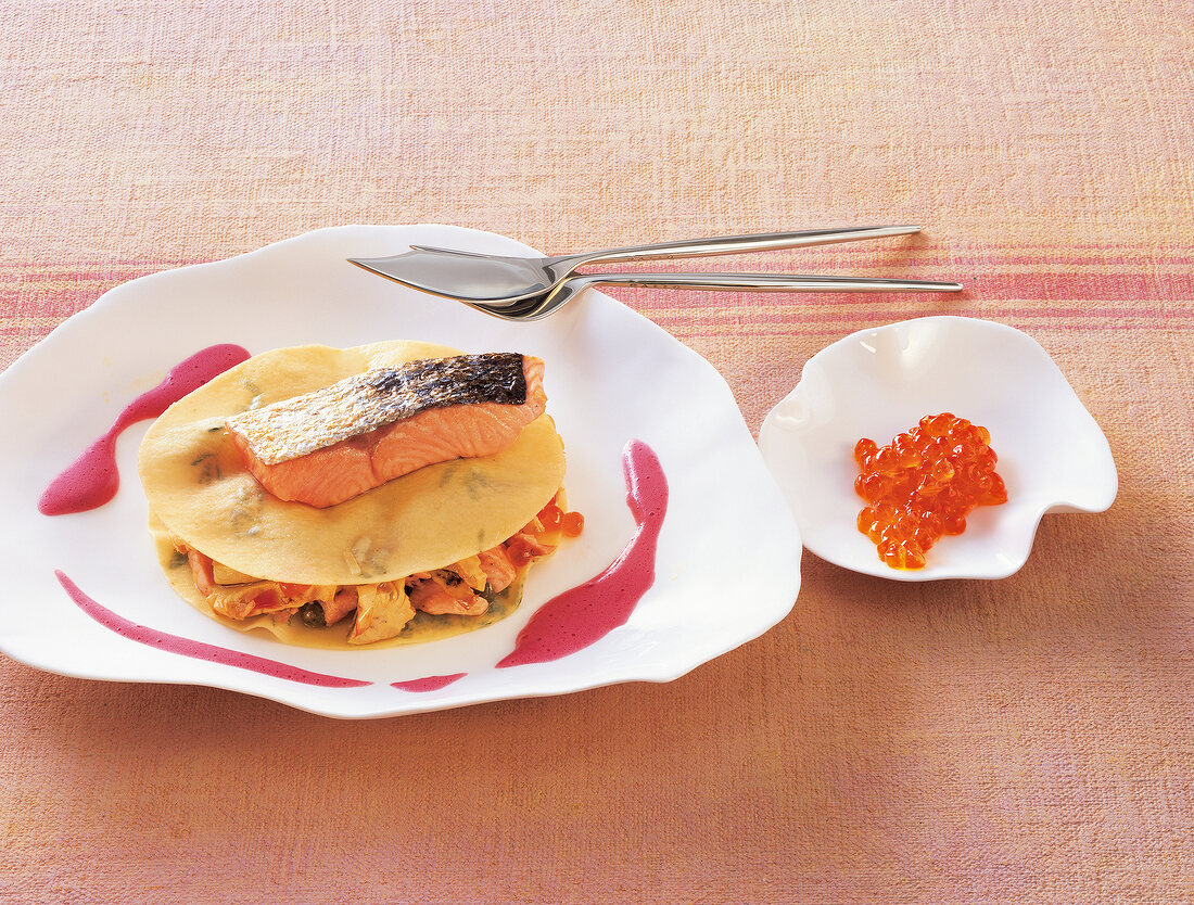 Ravioli with salmon and purple mustard sabayon on plate