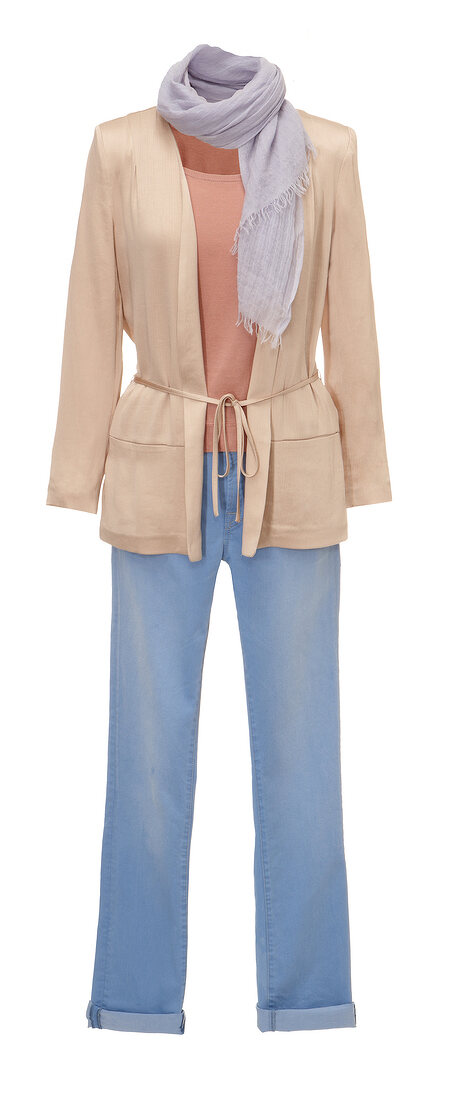 Beige cardigan, peach blouse and blue jeans on white background
