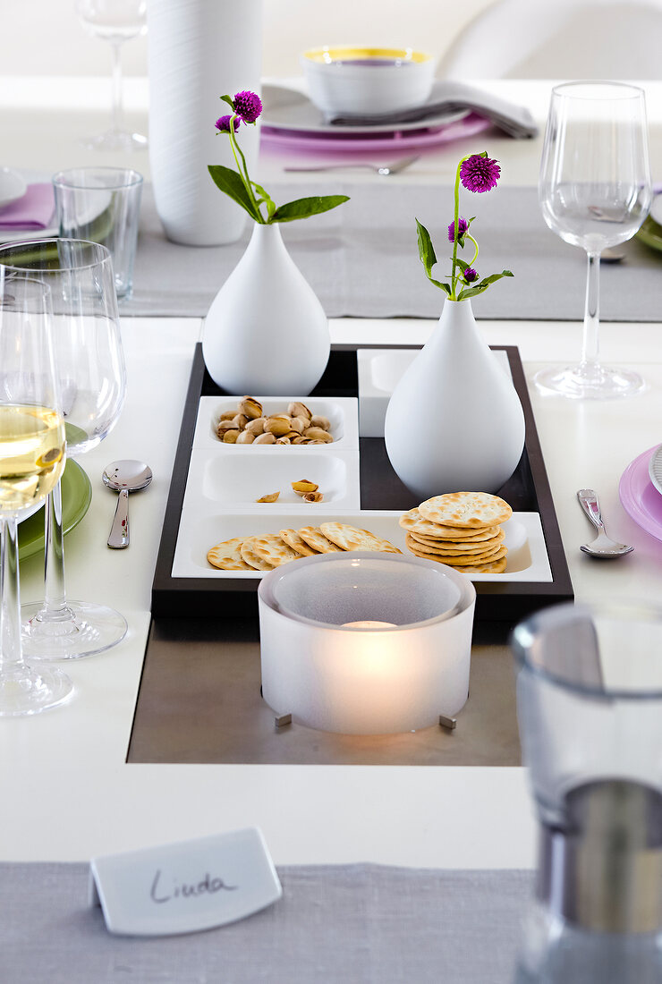 Dining table set up with lanterns and vases