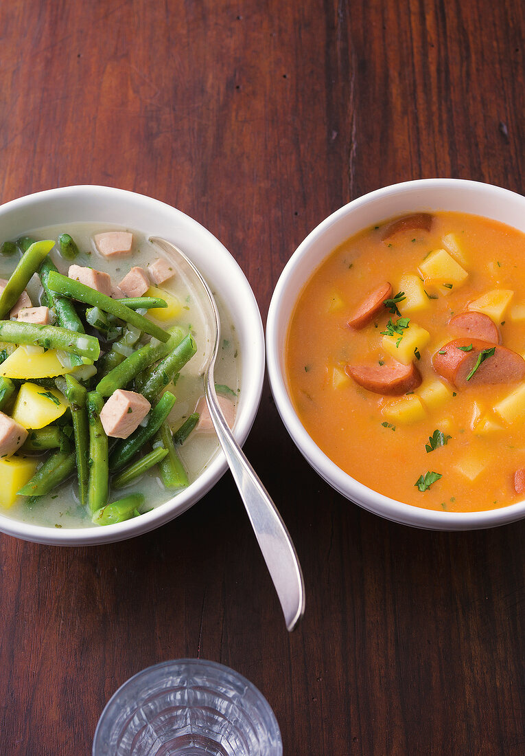 Close-up of bean stew and potato soup in bowls