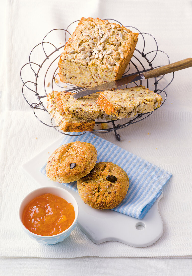 Gluten free rice bread and multigrain bread in bowl and on chopping board with dip