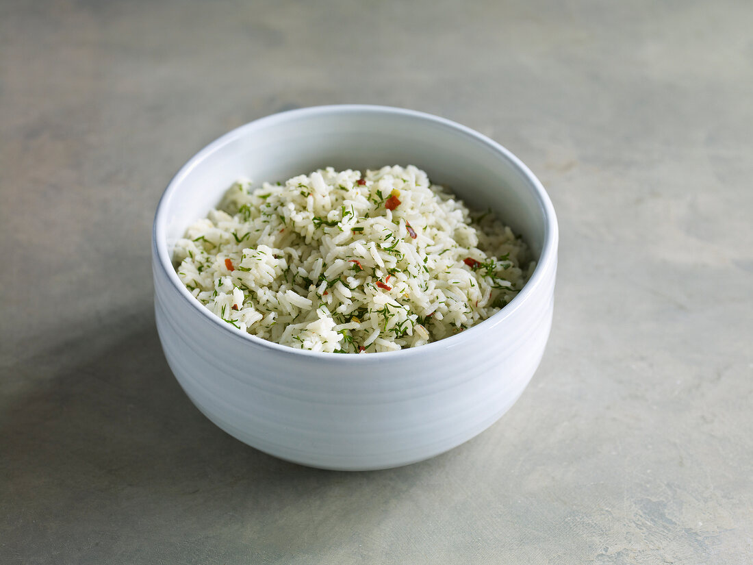 Rice with dill and pepper in bowl
