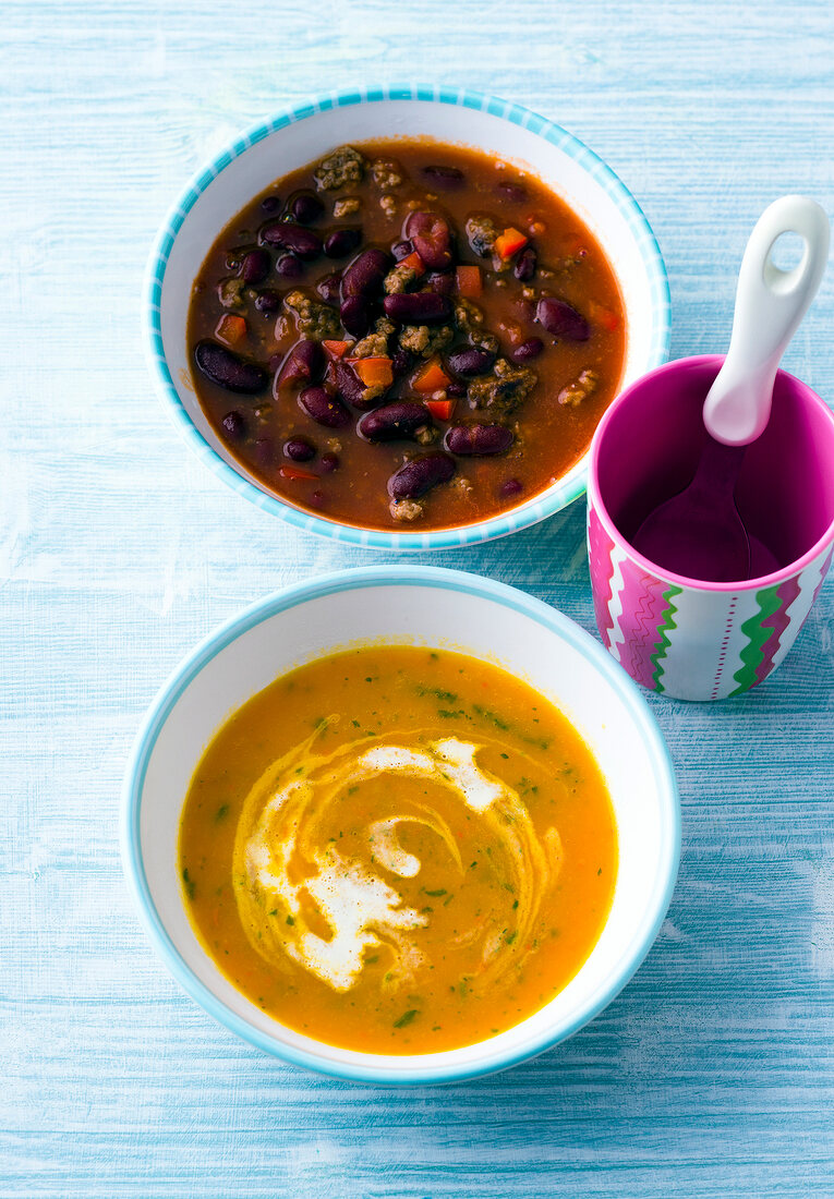 Vegetable soup and pumpkin soup in bowls