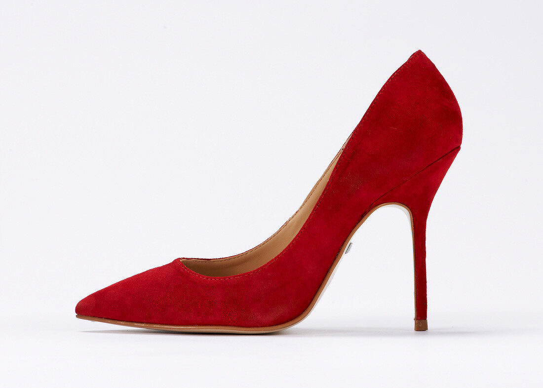Close-up of red stiletto pumps on white background