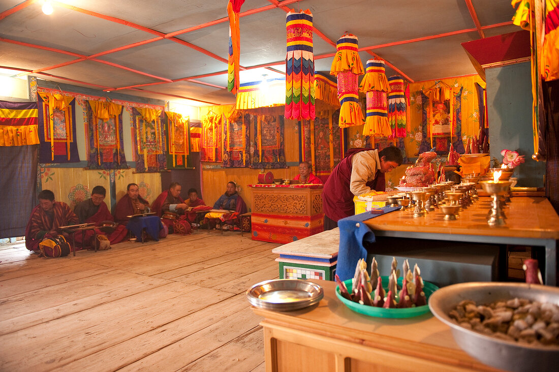 People praying at prayer hall of school, Ura valley, Bhutan