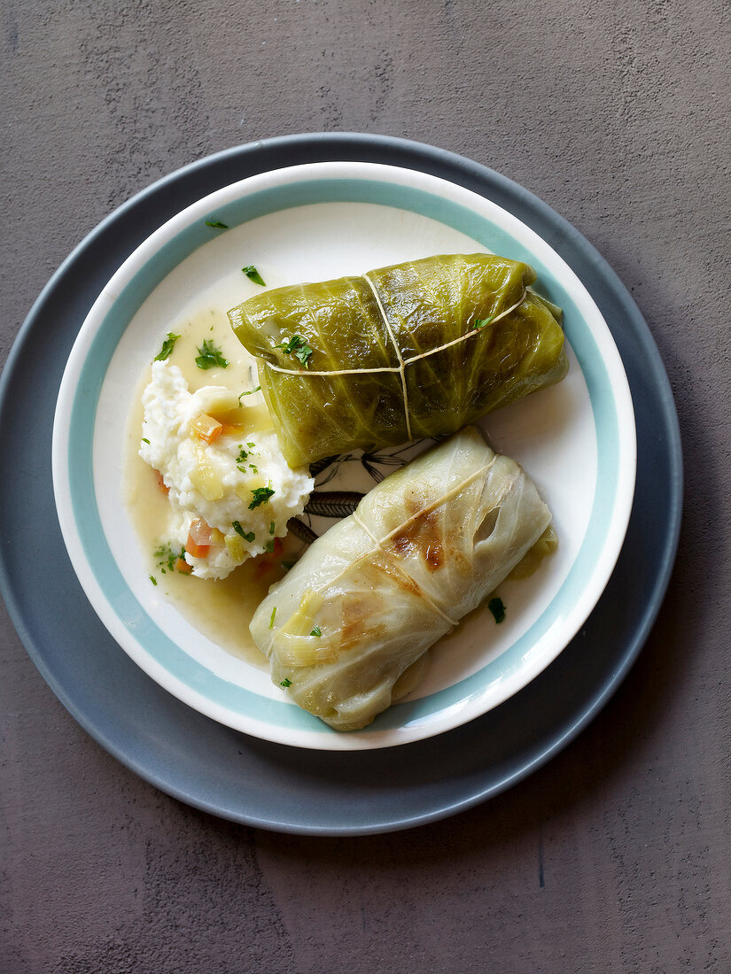 Cabbage rolls stuffed with mashed potatoes on plate