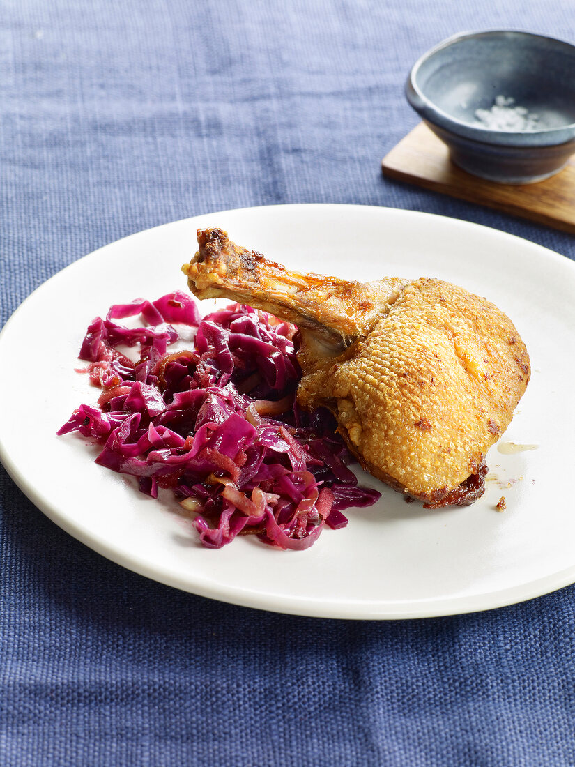 Close-up of roasted duck with red cabbage on plate