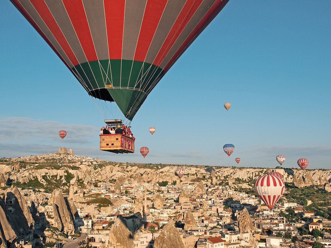 Hot air balloons in sky at Oreme Anatolian cave village, Cappadocia, Turkey