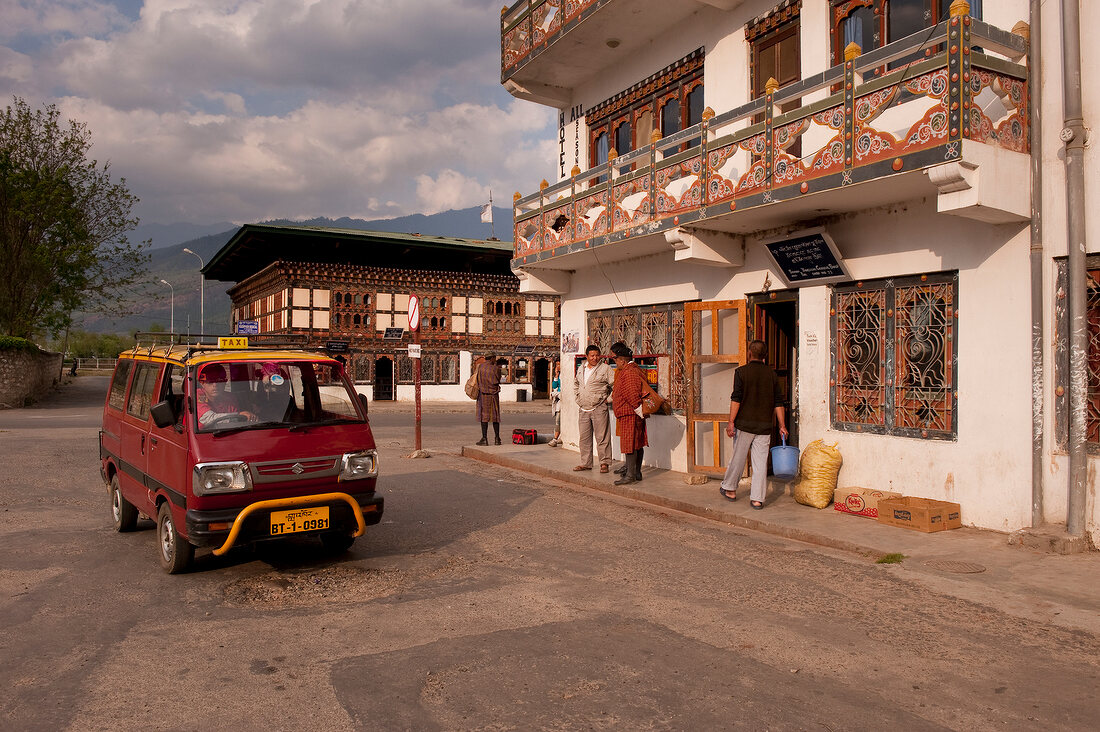 People waiting at bus stop in downtown Paro, Bhutan