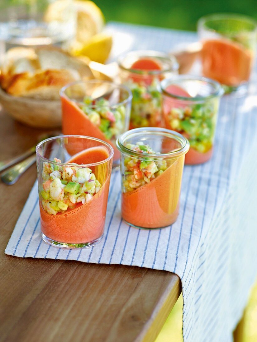 Tomato pudding in glasses at an angle on a table outside