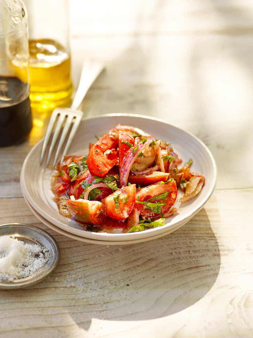 Tomato salad with gold apples on plate