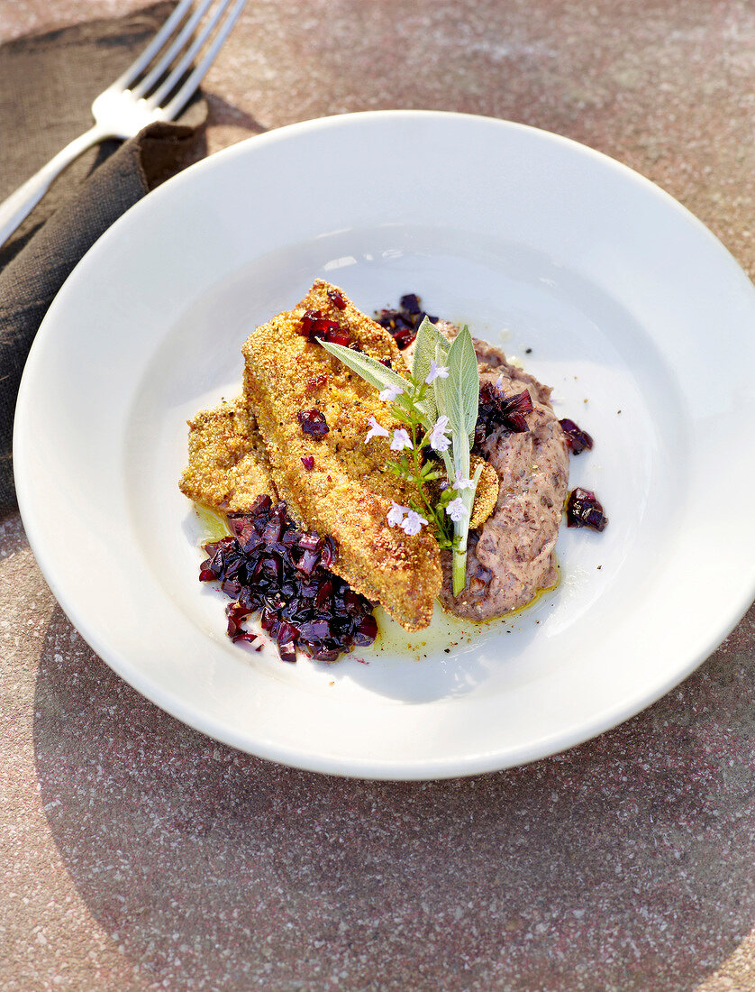 Veal liver with bean puree on plate during summer, Italy