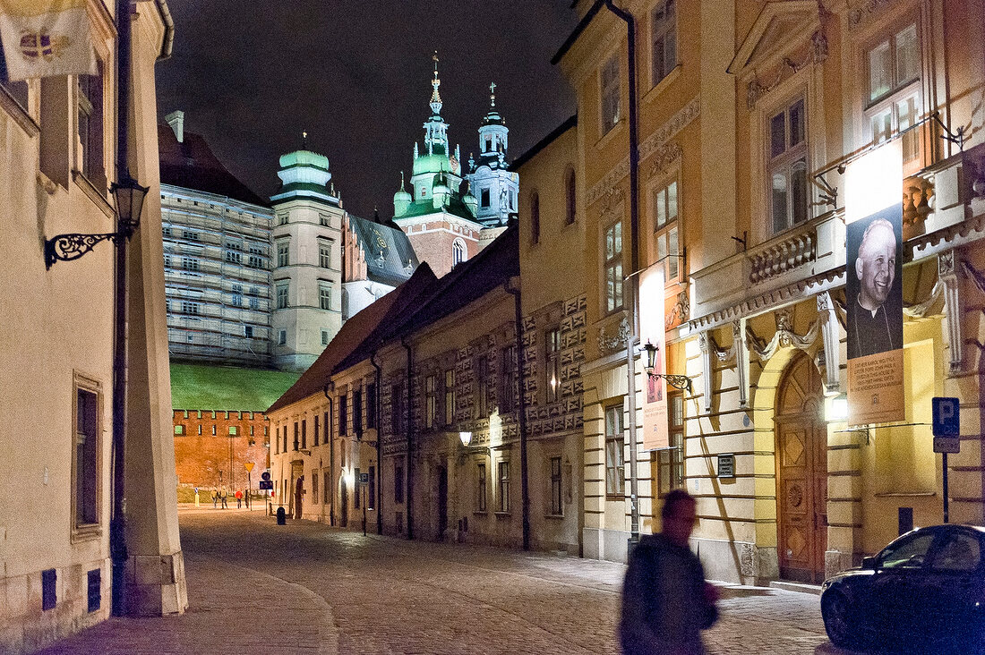 View of illuminated Wawel castle and old town in Krakow, Poland, blurred motion