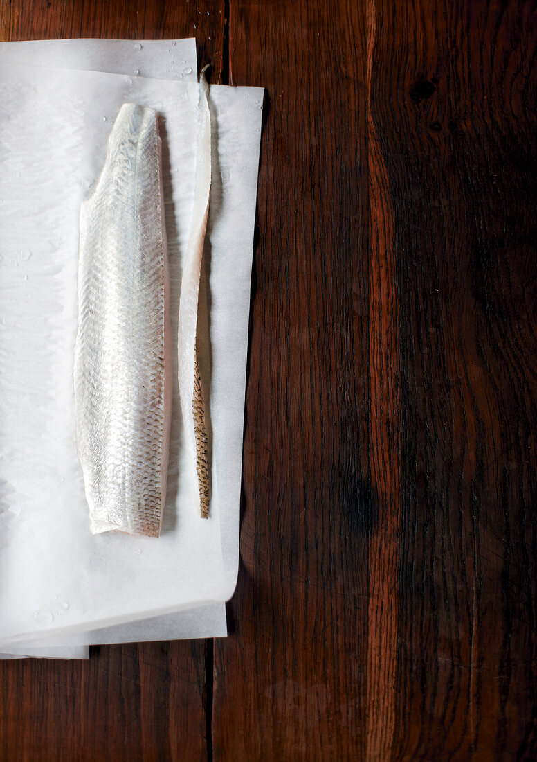 Fillet of whitefish and fera on baking sheet, overhead view