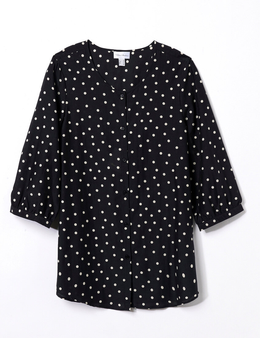 Close-up of black polka dot shirt blouse on white background