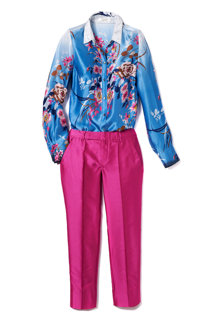 Floral pattern silk blouse with pink pleated pants on white background