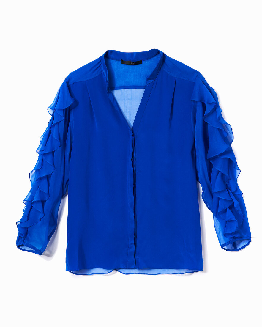 Close-up of blue shirt blouse with ruffles sleeves on white background