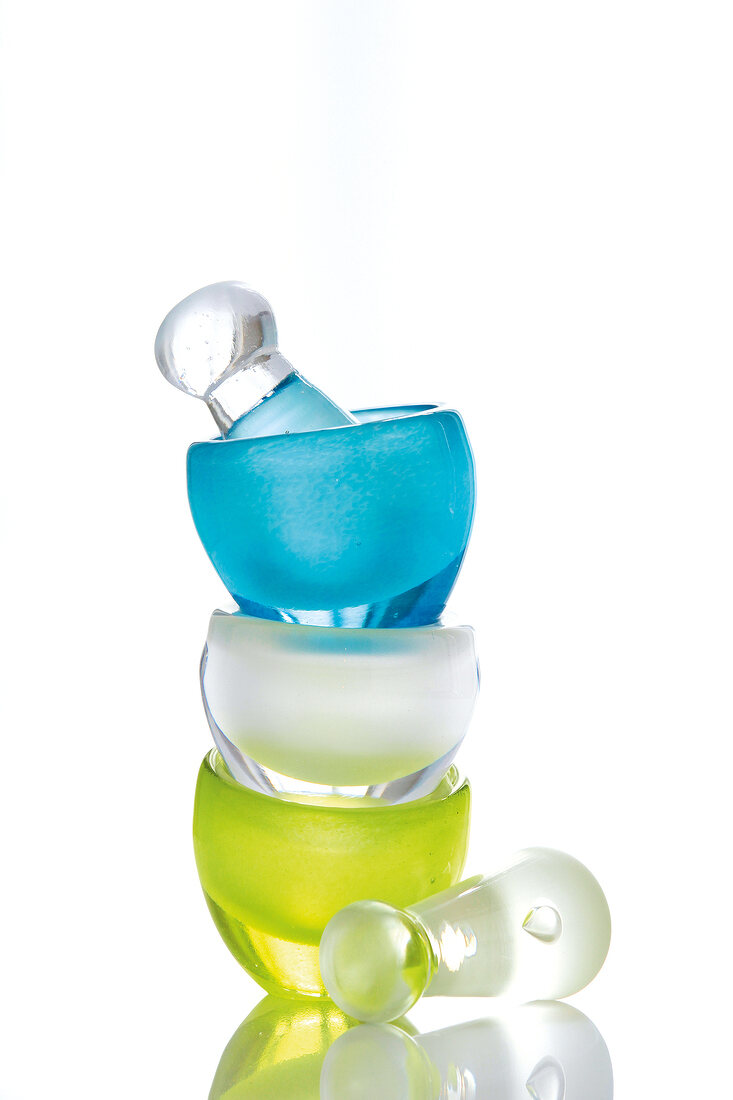 Mortar and pastel made of colourful glass on white background