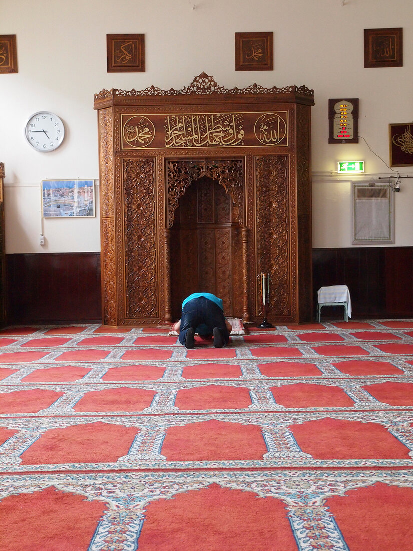 Rear view of man praying in mosque, De Pijp, Amsterdam, Netherlands