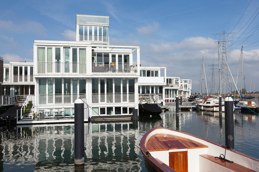 View of boats and facade of Waterwoningen in IJburg, Steigereiland, Amsterdam, Netherlands