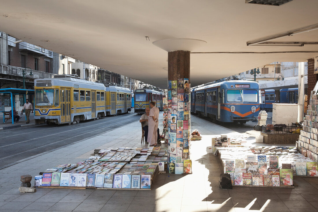 Trams and newspaper stand at tram station in Alexandria, Egypt