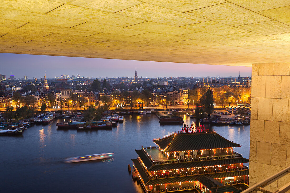 View of illuminated Old Town from roof terrace of public library, Amsterdam, Netherlands