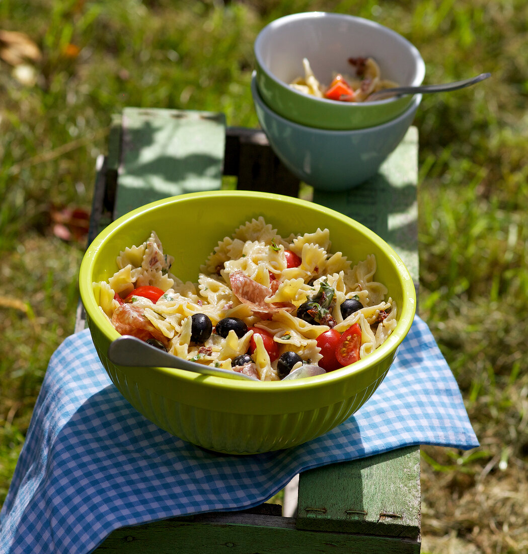 Pasta salad with cherry tomatoes and olives in bowl