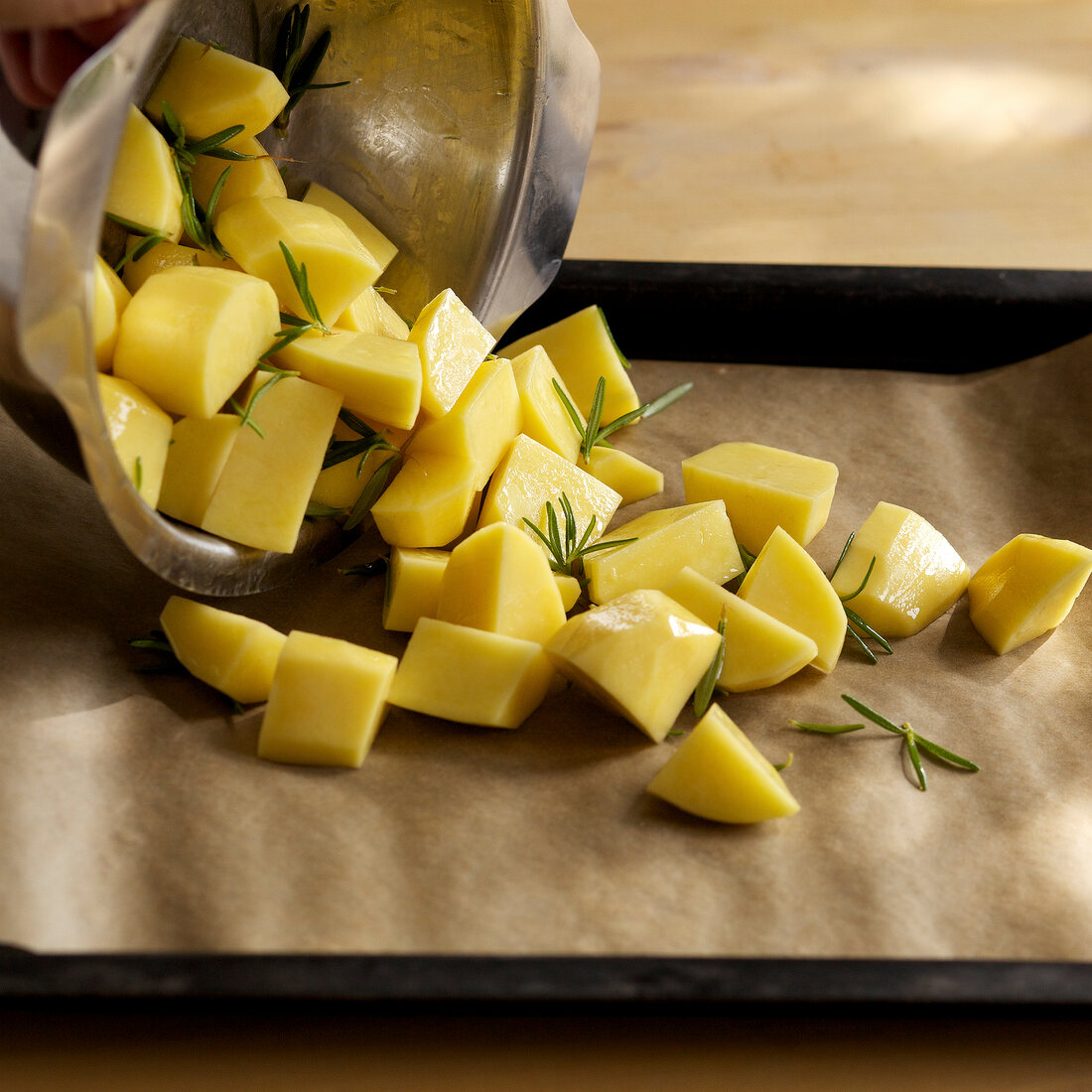 Close-up of potatoes pieces on baking sheet, step 1