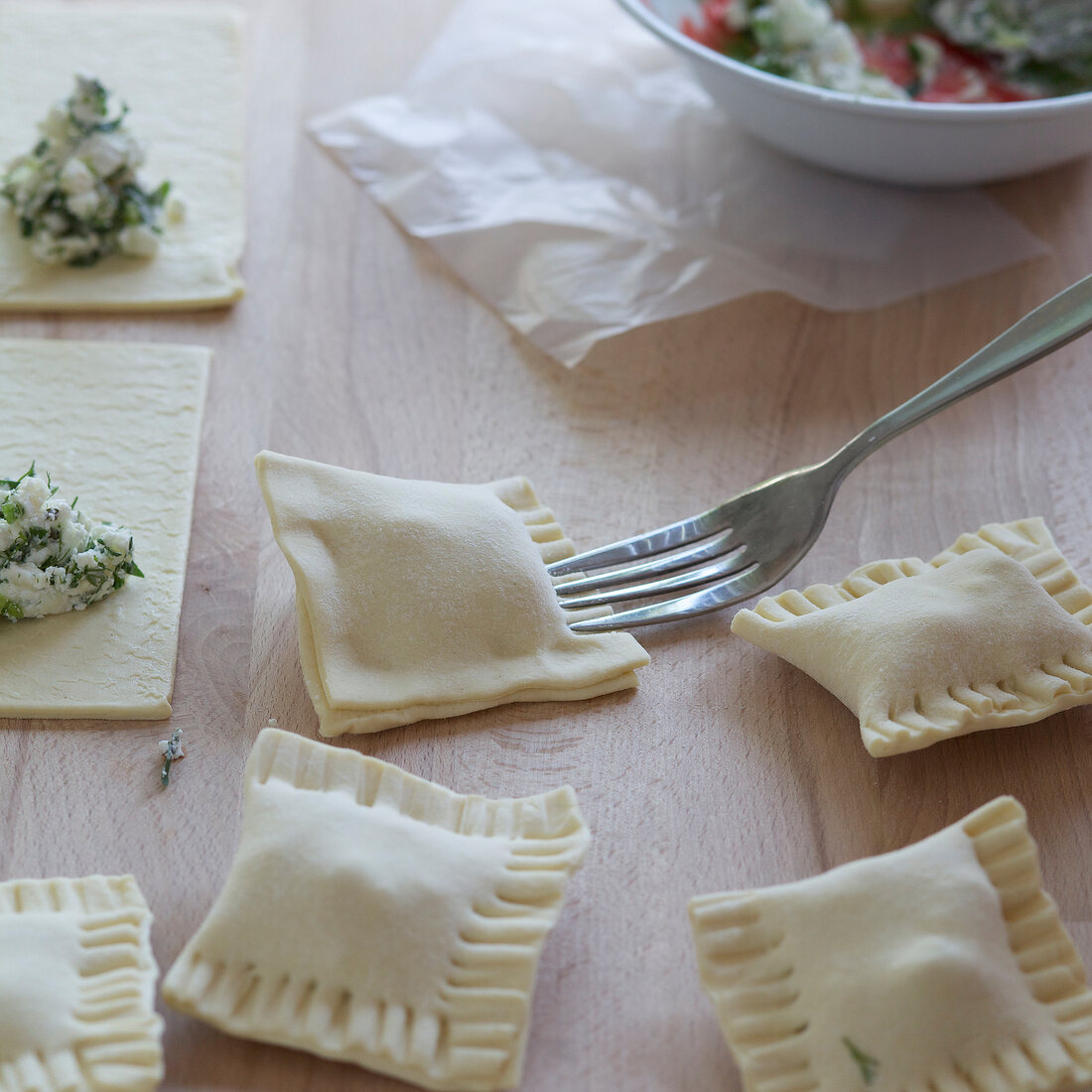 Close-up of stuffed dough being poked with fork, step 2