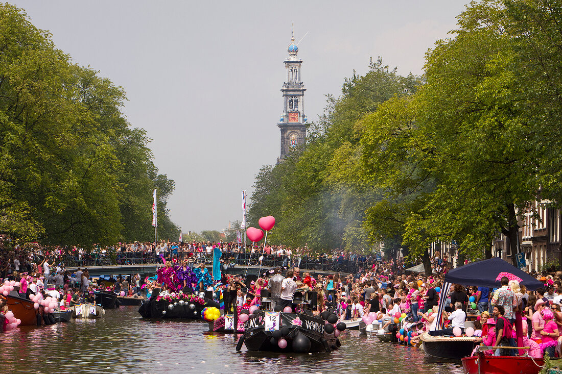 Crowd on boats for gay pride canal parade in Prinsengracht, Amsterdam, Netherlands