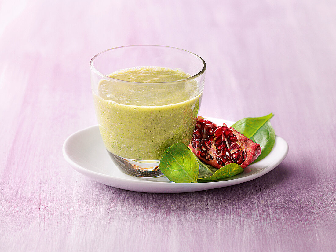 Glass of green smoothie for female's well-being
