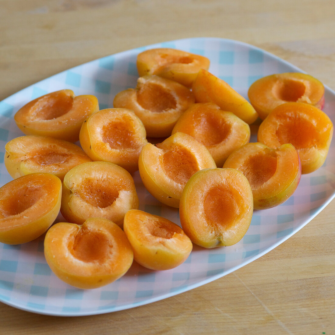 Close-up of halved apricots on plate, step 1