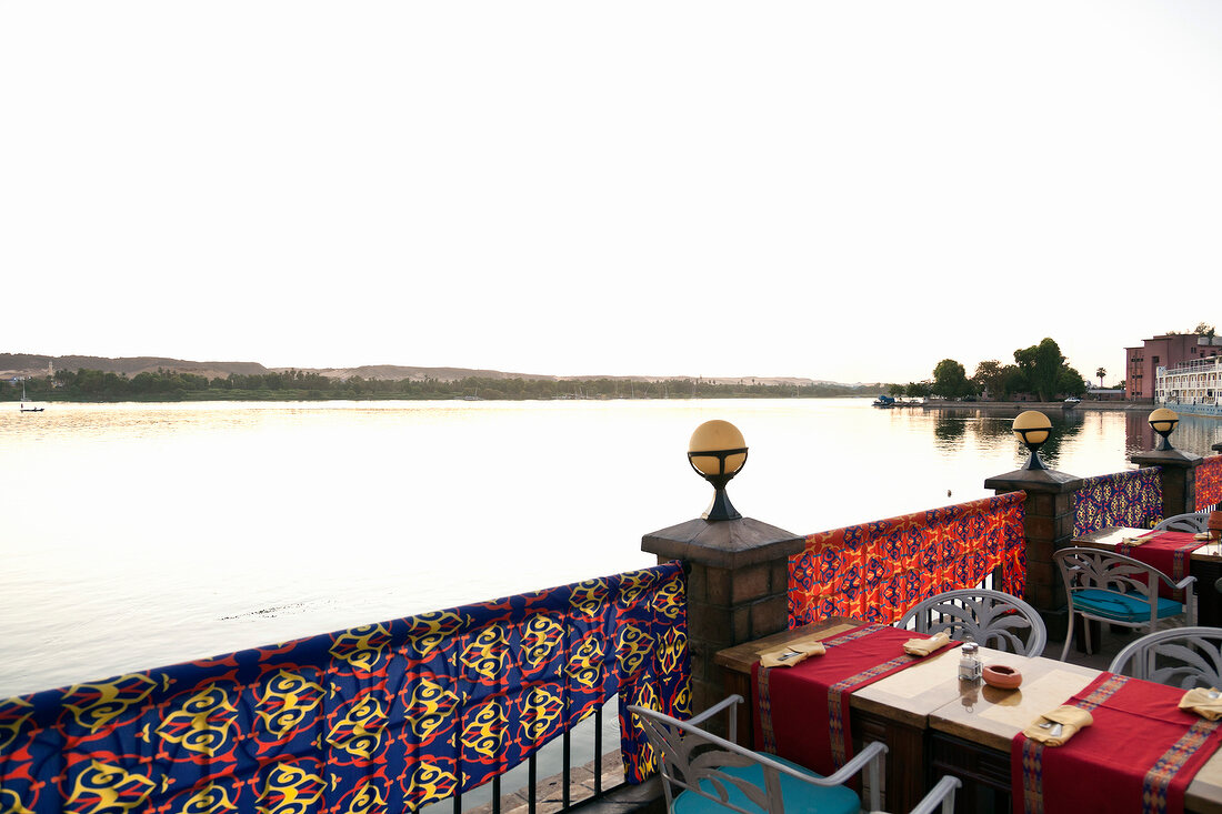View of river and table laid on the terrace of Aswan Hotel, Aswan, Egypt