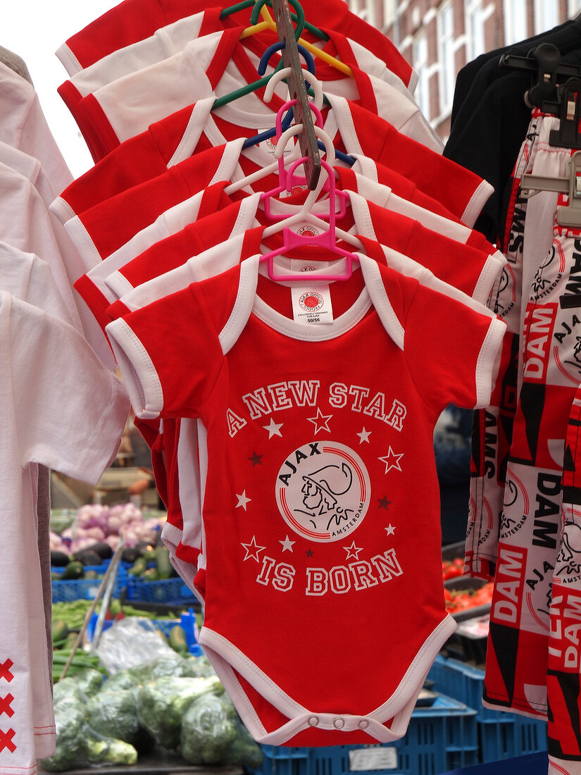 Arrangement of red baby clothes in Albert Cuyp Market, De Pijp, Amsterdam, Netherlands