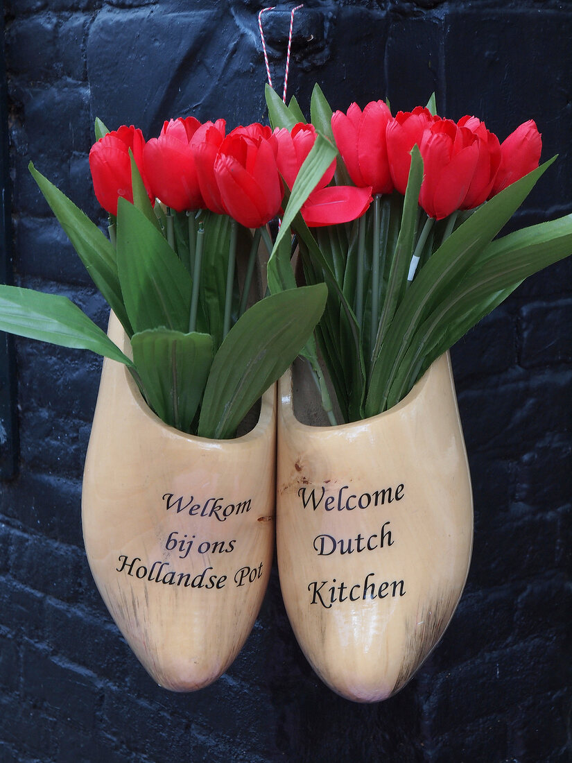 Close-up of clogs with tulips at Bistro bij ons, Amsterdam, Netherlands