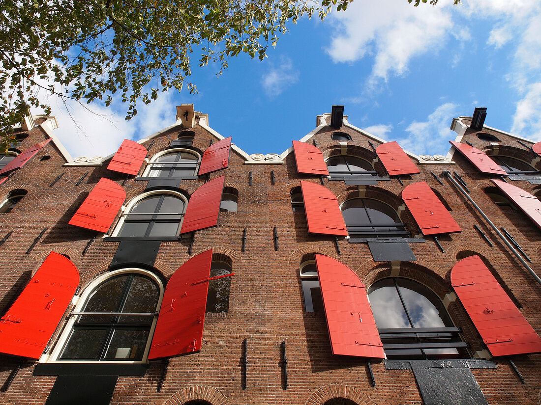 Row of houses with red shutters in Prinsengracht, Amsterdam, Netherlands