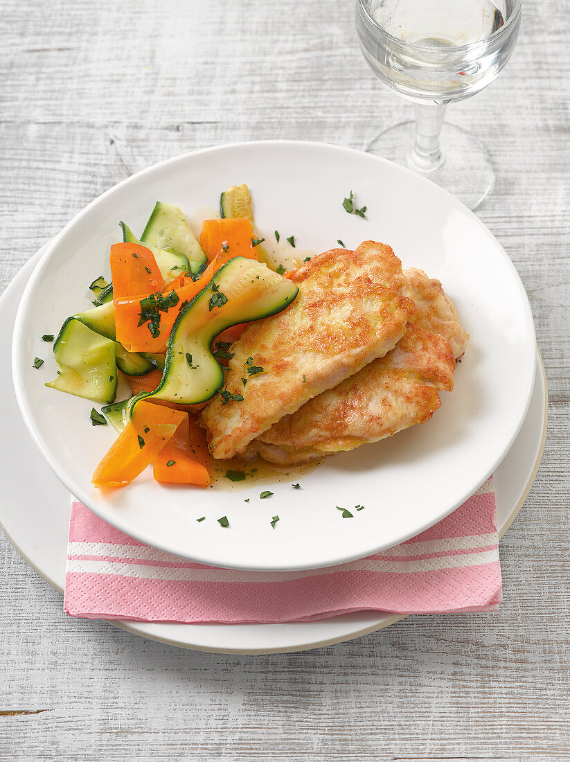 Chicken piccata with vegetable noodles on plate