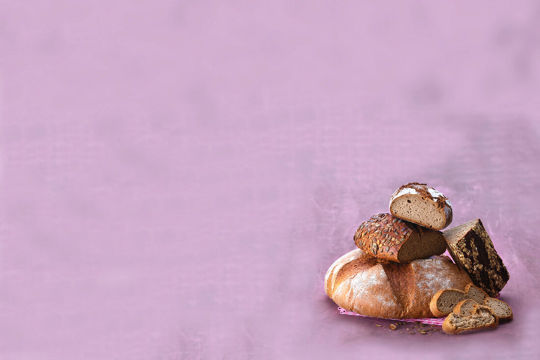 Various kinds of bread on purple background