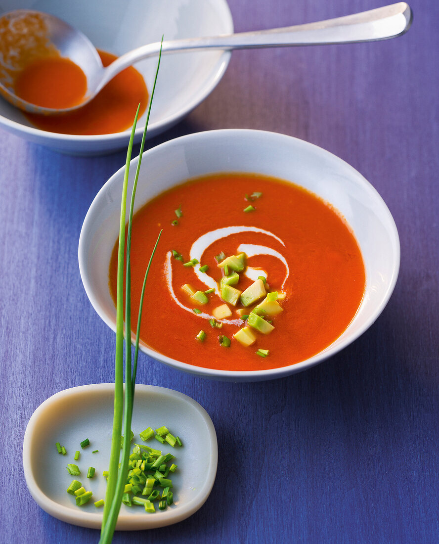 Chilli and tomato soup with avocado in bowl