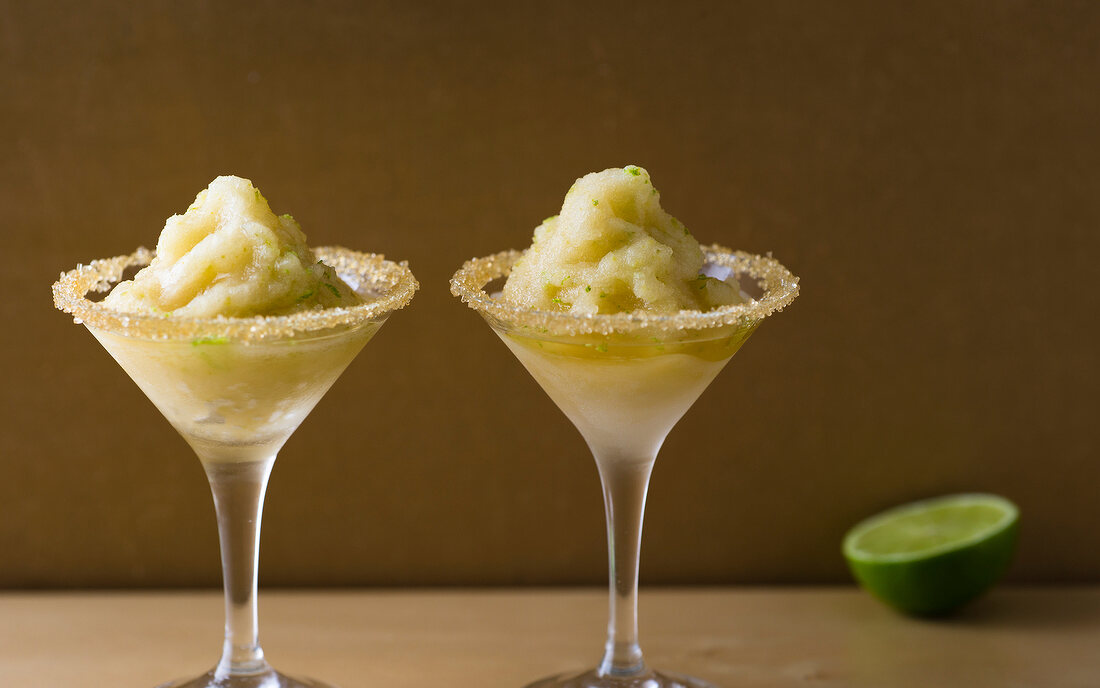 Caipirinha sorbet in cocktail glasses with decorated glass rim