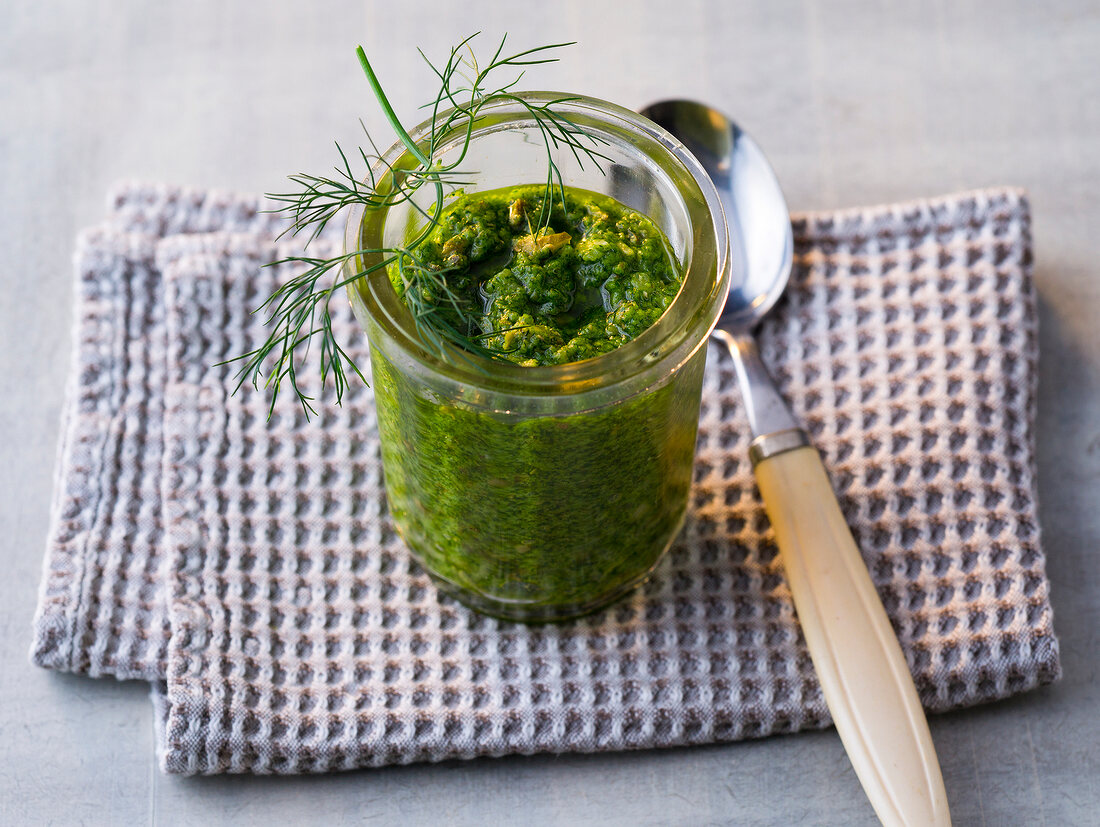 Glass of salsa verde with dill on folded napkin