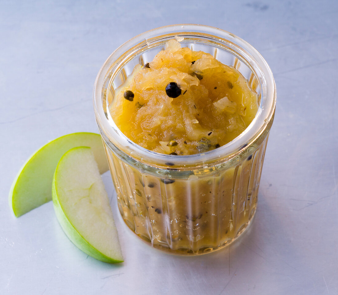 Glass of apple chutney with black pepper