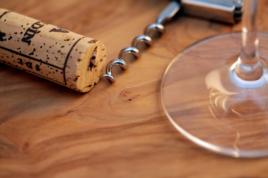 Wine cork with corkscrew on white background